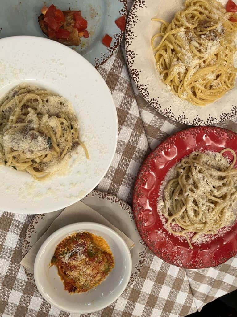 several pasta dishes being severed in Positano, Italy