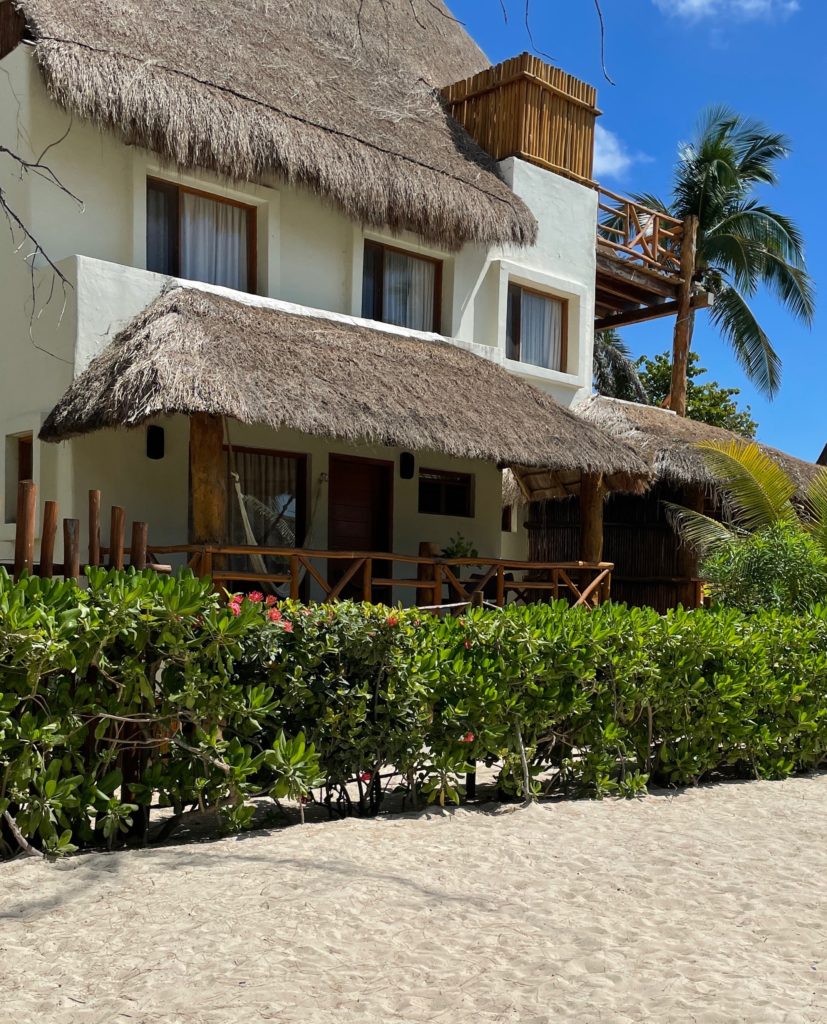 beach house with classic palapa sides on the roof on a beach in Playa Del Carmen beach tap
