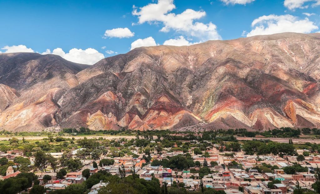Small city alongside colourful mountain in Argentina 
