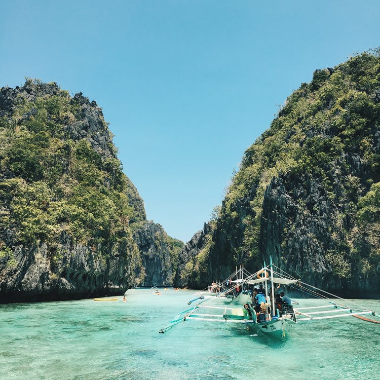 Boats sailing onto islands in the Philippines