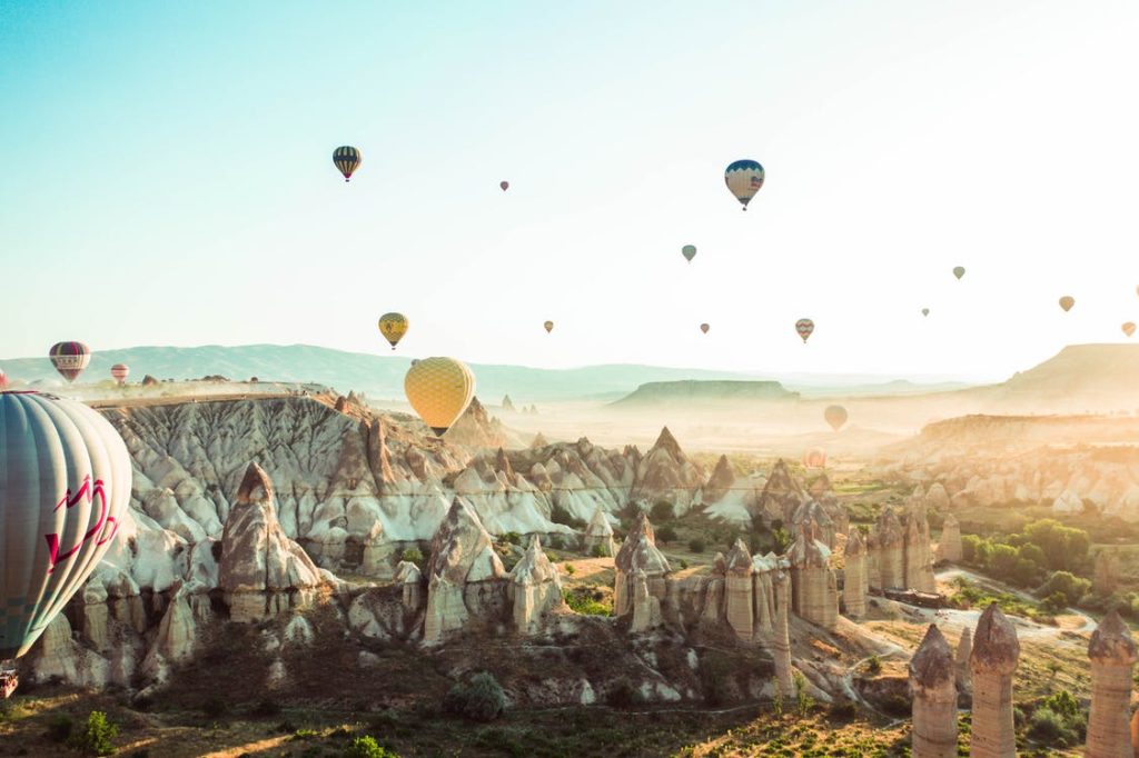 Hot air balloons riding around the city of Cappadocia Turkey