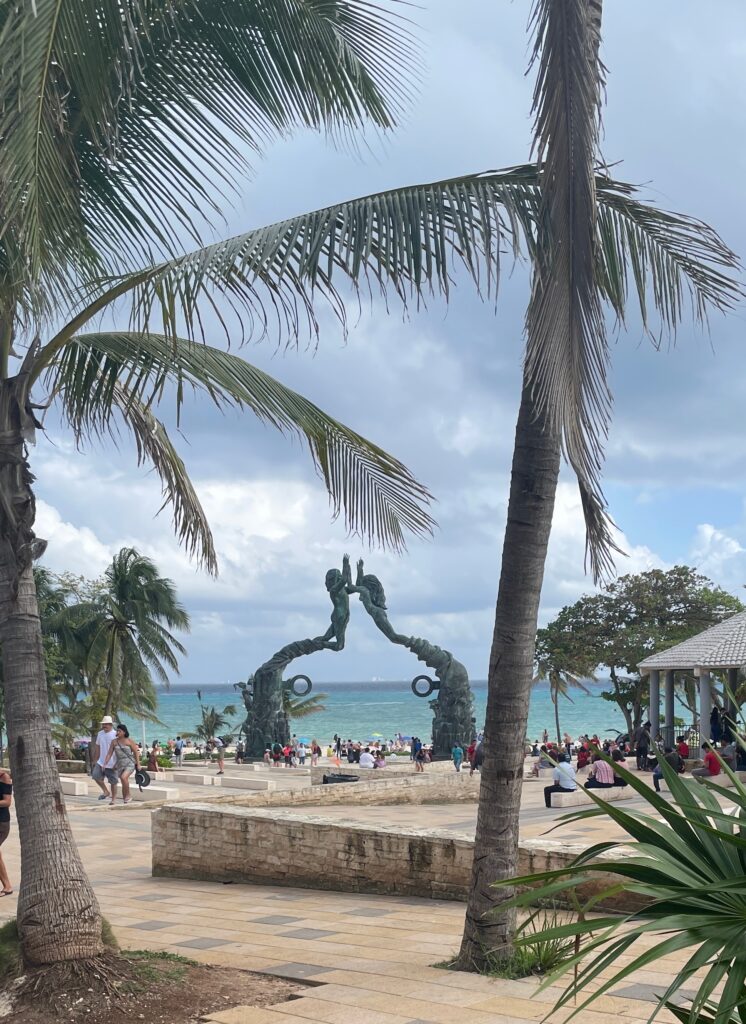 Photo of Playa Del Carmen Beach in Mexico showing statue of two mermaids