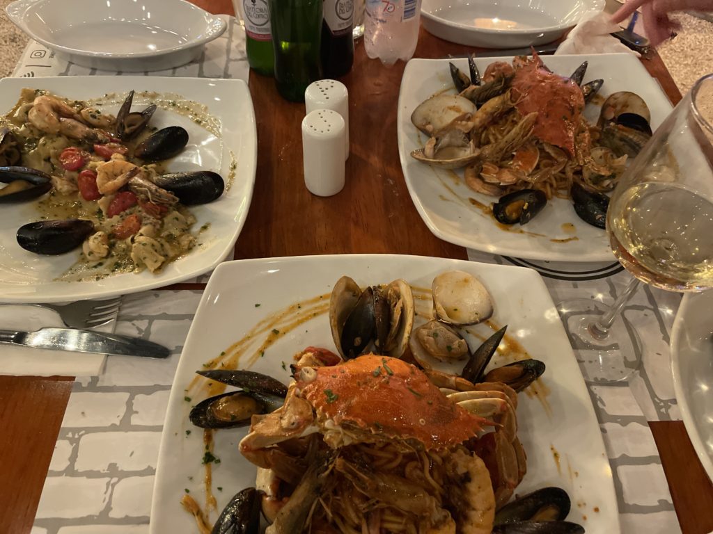 several Italian seafood pastas on a table at Trattoria del centro in playa del carmen, one of the best playa del carmen italian restaurants