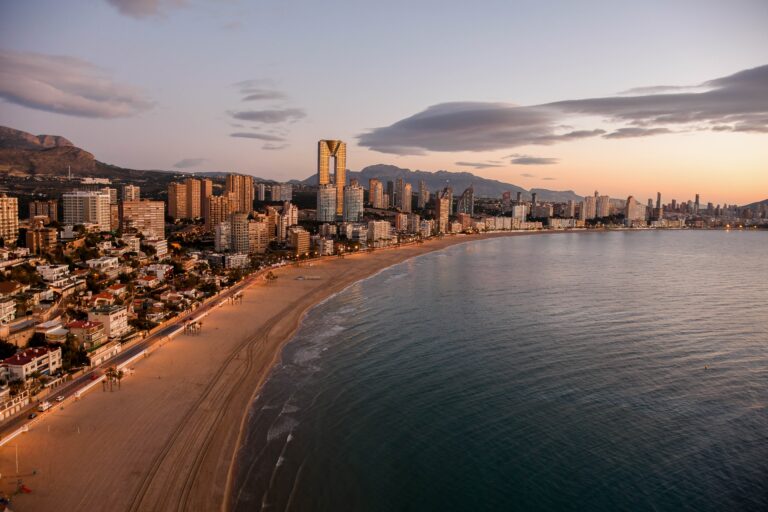 skyline of Benidorm Spain alongside the long beach shoreline in the evening