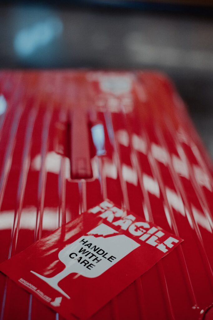 suitcase labeled with fragile sticker at airport