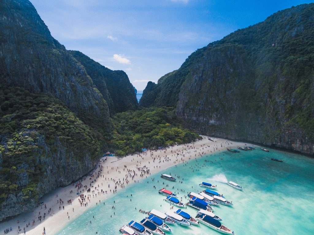 aerial view of many tourists and boats visiting the world-famous Maya Beach, a part of the Phi Phi Islands in Thailand