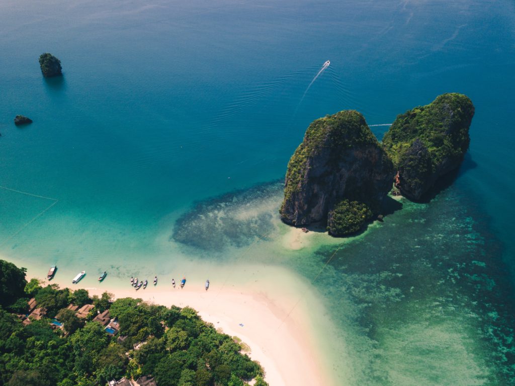 aerial photo taken from viewpoint of beach shoreline and turquoise coloured waters of Krabi island in thailand