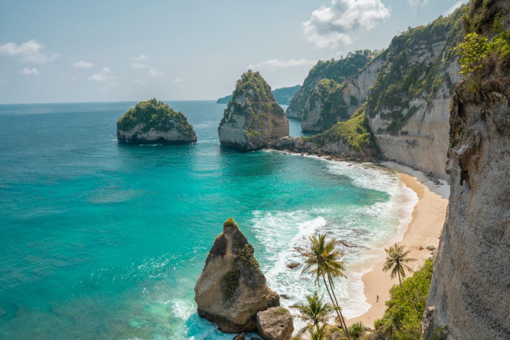 Pristine clear waters and giant high mountains at Nusa Penida in Bali, Indonesia