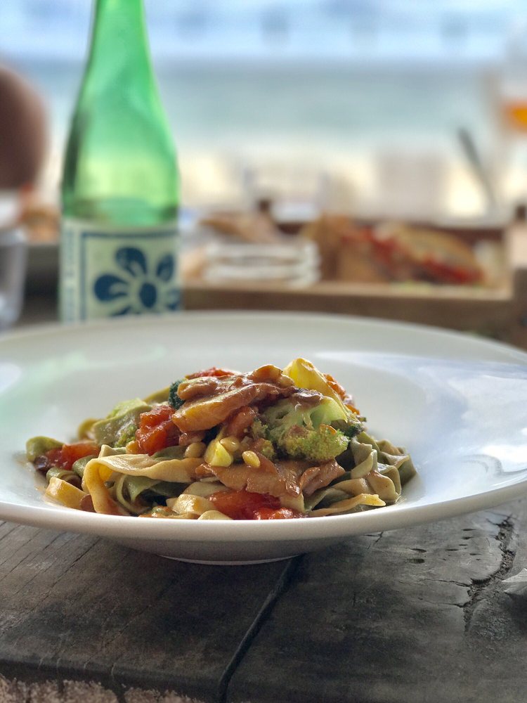 plate of pasta with ocean views being served at Posada Margherita in Tulum Mexico