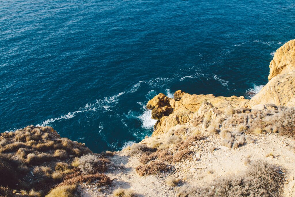 steep cliffs with harsh waves crashing at  Siera Helada Natural Park in Benidorm, Spain 