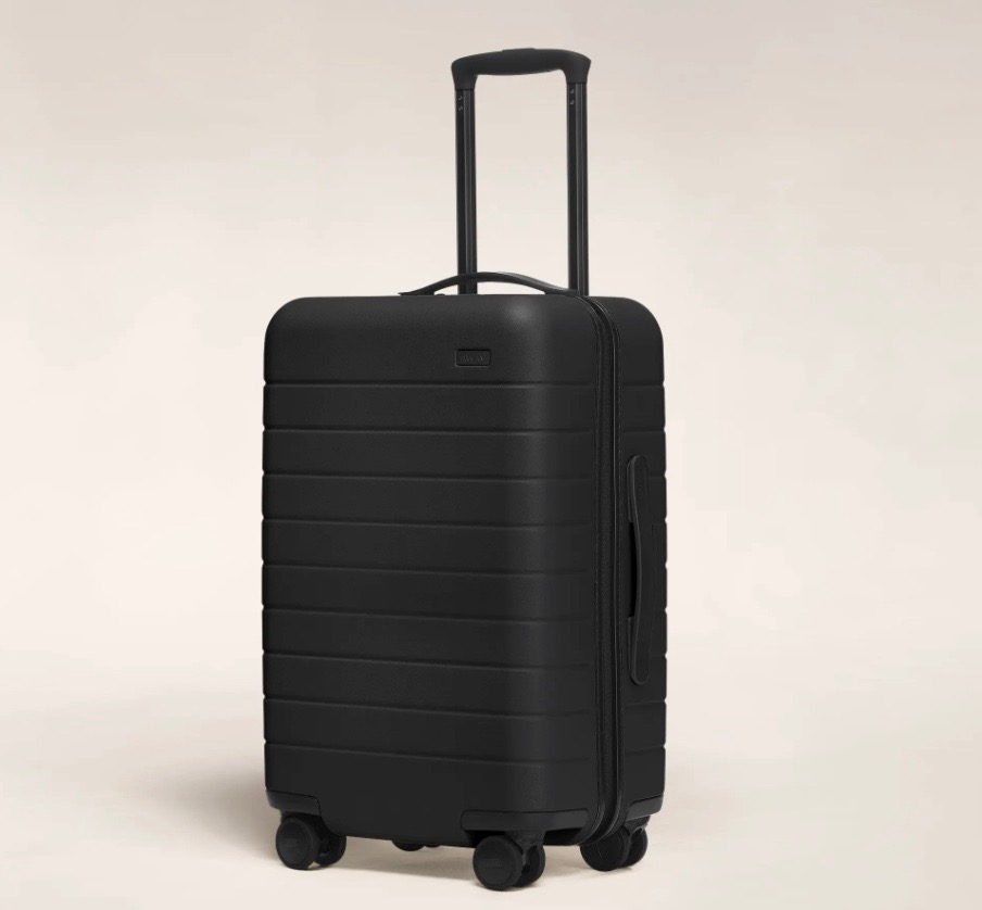 black away carry on luggage with a beige background