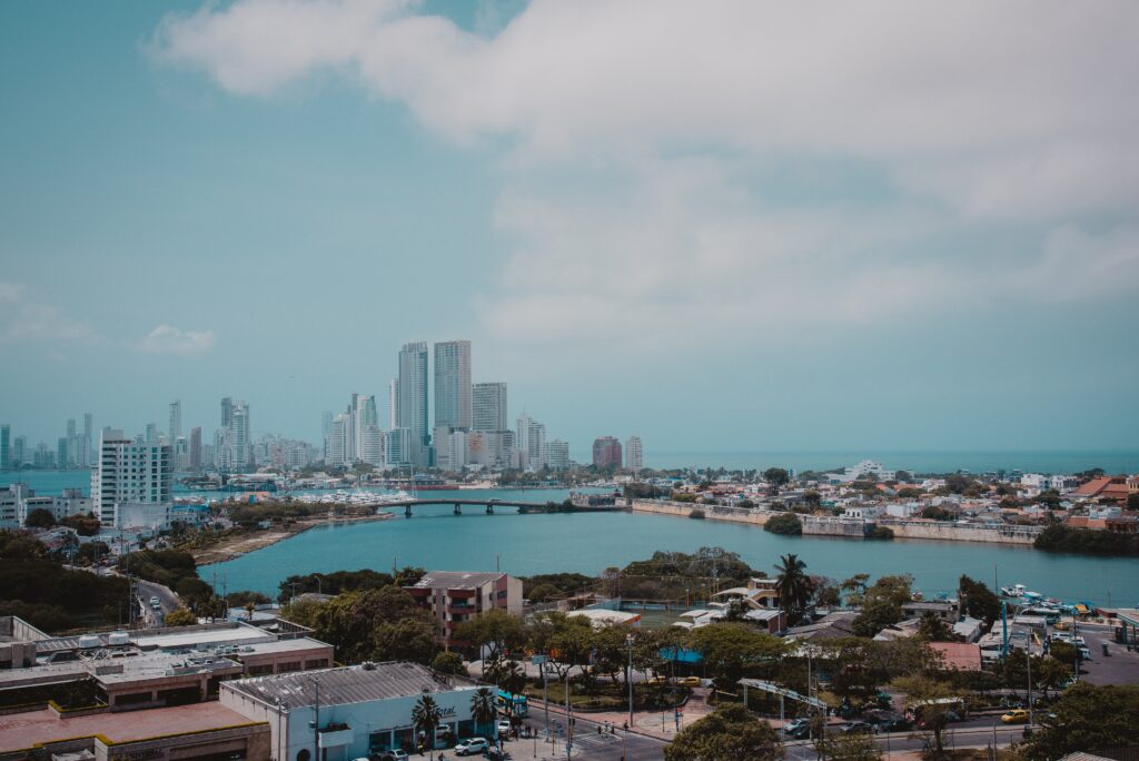 views of catagena city featuring the ocean amongst many tall buildings