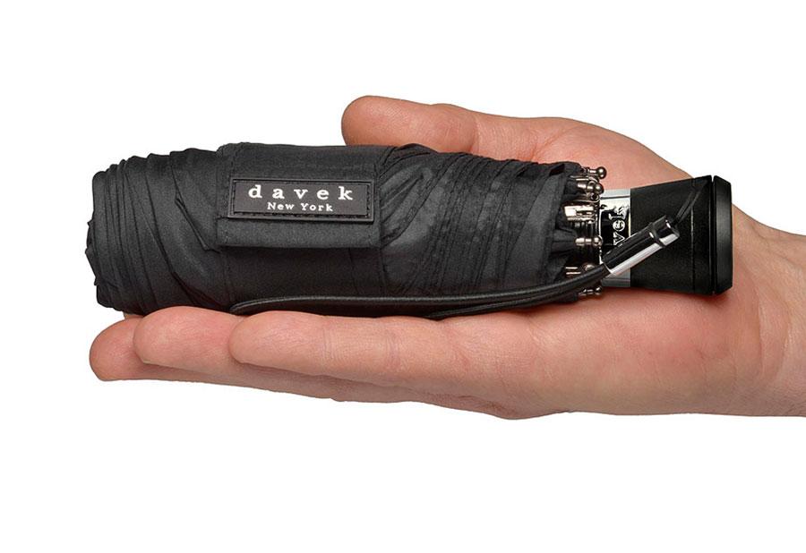 very compact umbrella being compared to a grown mans hand