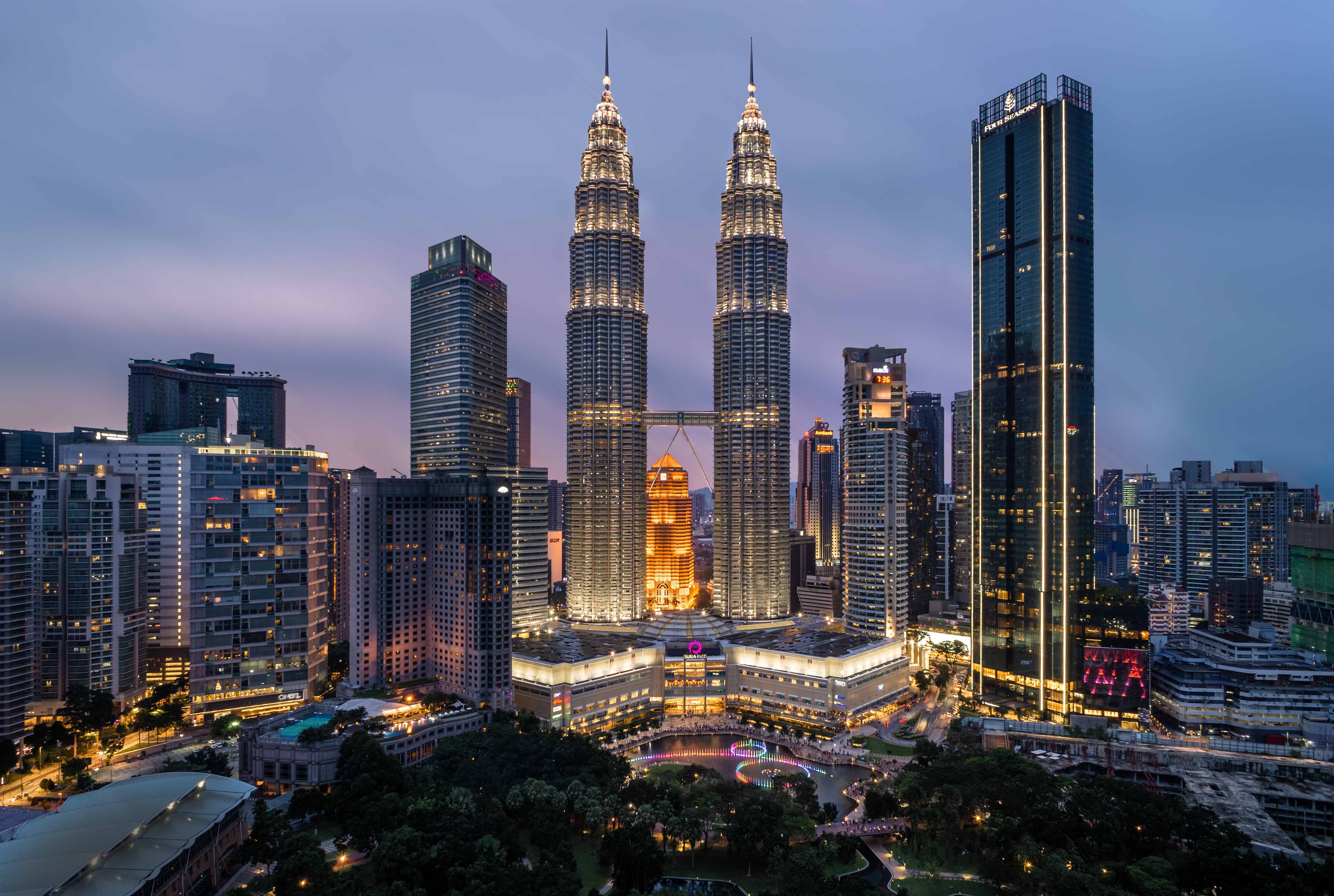 skyline at night of downtown Kuala Lumpur featuring the famous petronas towers in Malaysia cheapest places to live