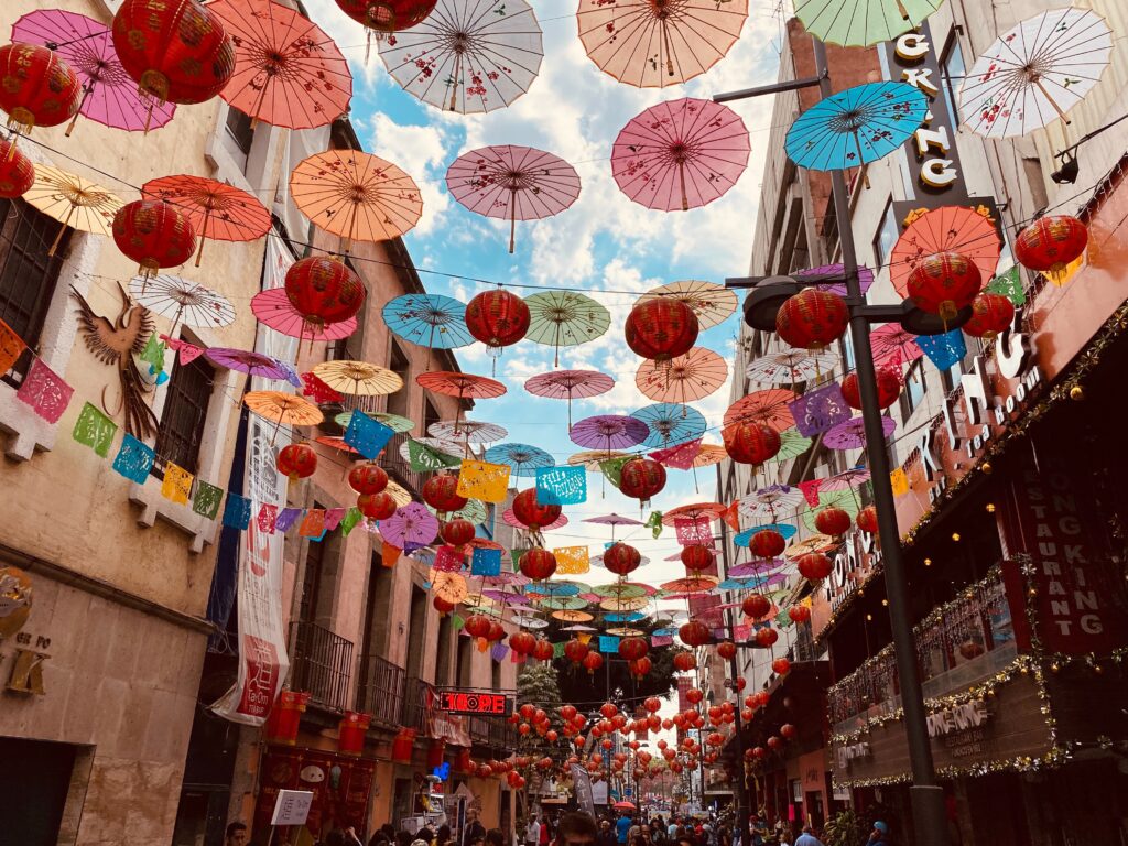 colourful paper umbrellas hanging in a street market street in Mexico City