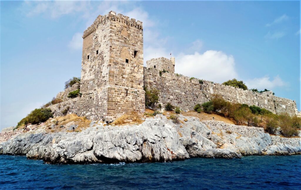 the famous Bodrum Castle sitting on a steep cliff along the sea 