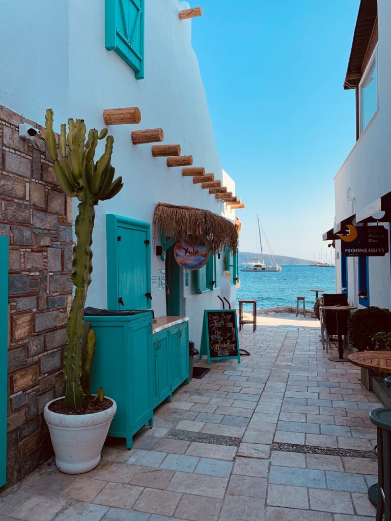 stores with a ceramic walkway towards the aegean sea and clear blue skies