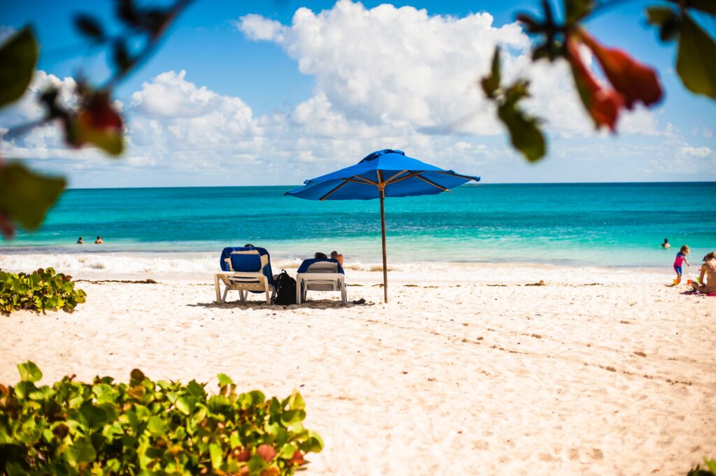 white sandy secluded beach with clear skies and turquoise waters in bridgtown Barbados 