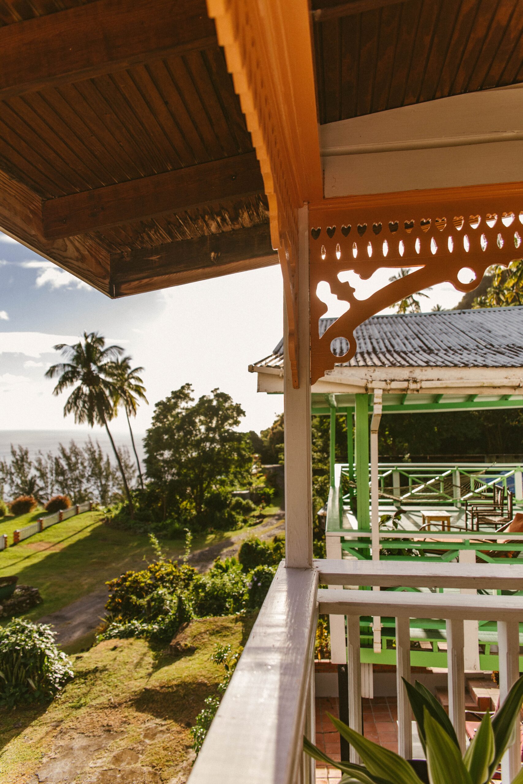 stunning rich greenery featuring several types of palm trees and the Caribbean sea from a balcony in St Lucia