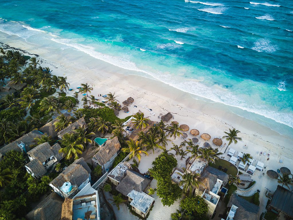 long beach shoreline filled with beachside homes in the famous city of Tulum Mexico