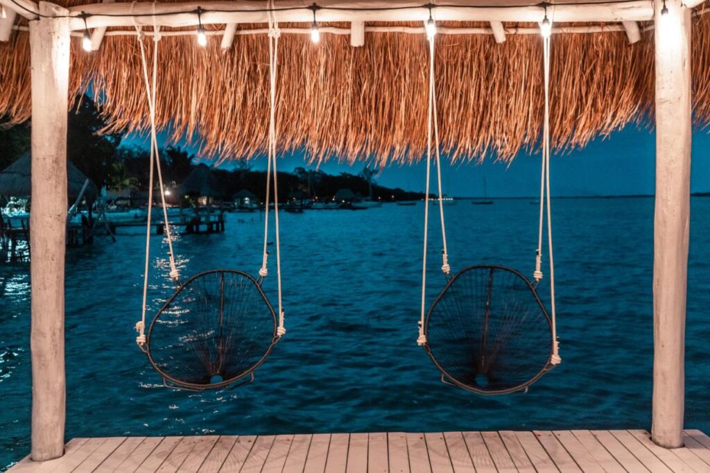 two swing chairs facing Bacalar Lagoon at the Royal Palm Bacalar Hotel