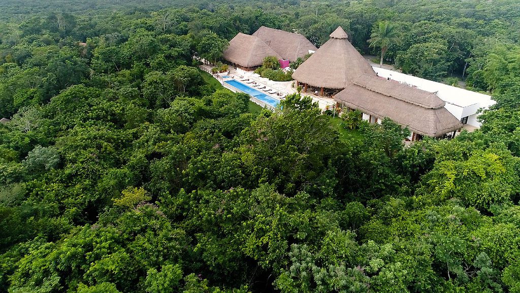 aerial view of The Explorean Kohunlich resort surrounded by dense forests in Bacalar, Mexico