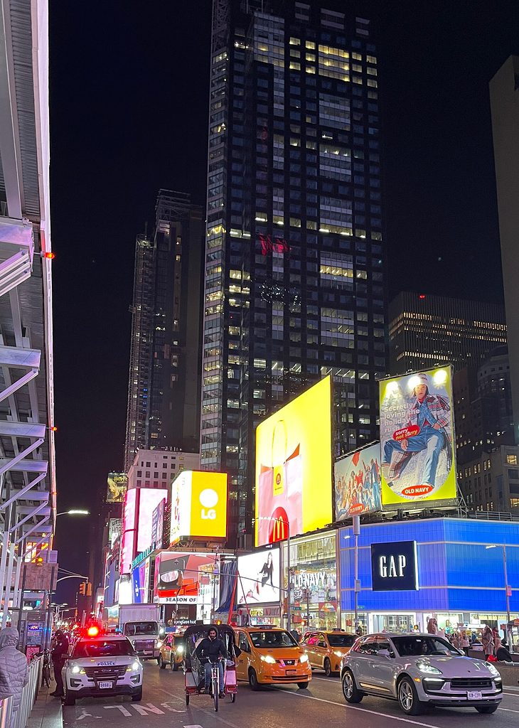 bright lit up buildings along the streets in Times Square, NYC