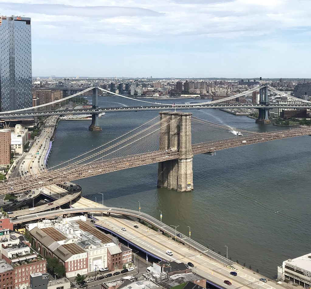 aerial views showing the Brooklyn Bridge and Manhattan bridge along the East River between New York City and Brooklyn