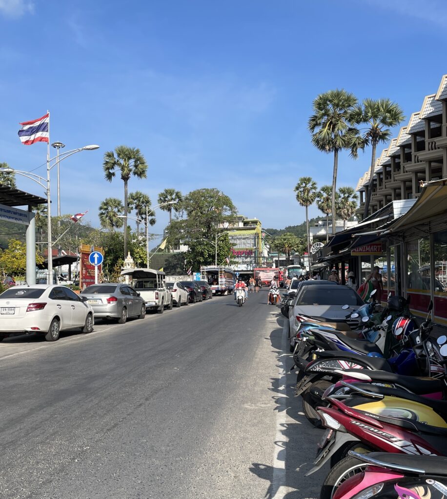 several scooters parked on a street in Kata Beach Phuket