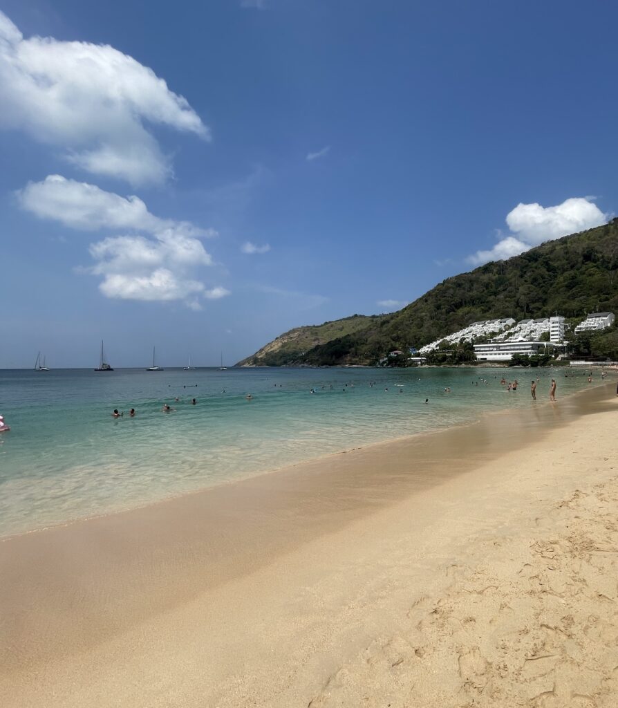 turquoise waters with clear skies and an empty Nai Han Beach in Phuket