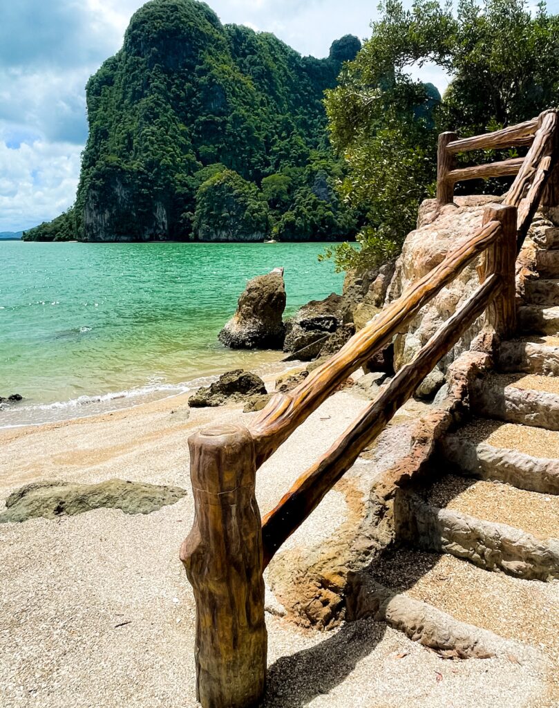 clear turquoise waters and stairs towards a hike at NGA BAY