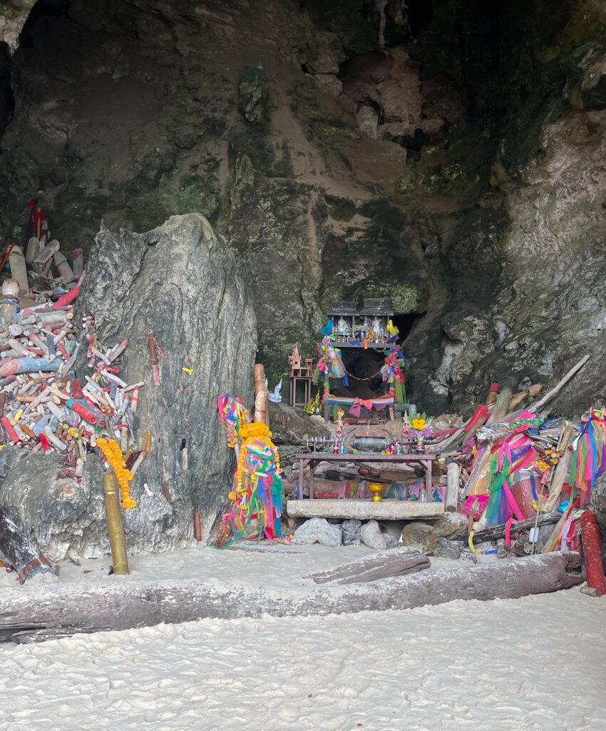 several wooden statues in a small cave named Princess Cave in Railay Krabi