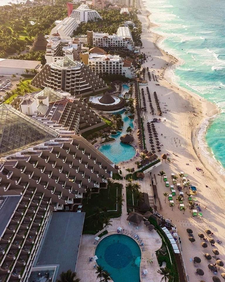 aerial views of a large resort along the Hotel Zone in Cancun with extensive beach shorelines, pitting Tulum vs Cancun