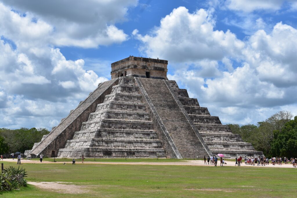 several tourist taking photos of the world-famous El Castillo pyramid in Chichen Itza