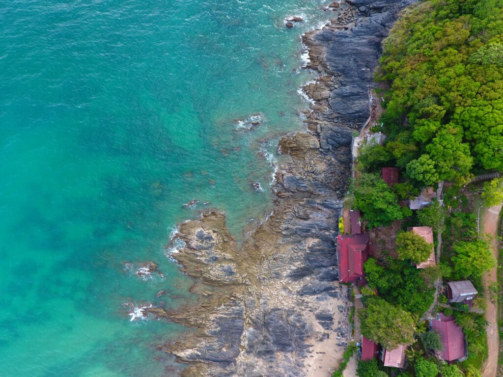 aerial view of a beach in Ko Lanta, Thailand, several homes facing beach coastline