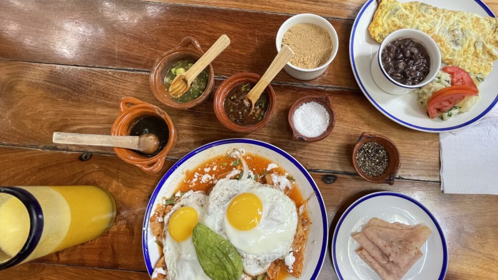 classic Mexican breakfast being served with several hot sauces on the side at La Cueva Del Chango restaurant in Playa Del Carmen