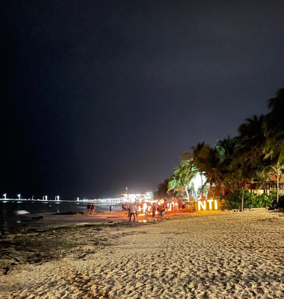 several lights at a beachclub in the evening on Playa Del Carmen main beach at night