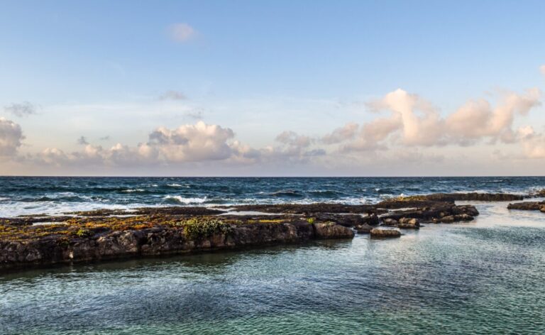 large rocks along a shoreline with clear skies just south of Puerto Aventuras / things to do in Puerto Aventuras