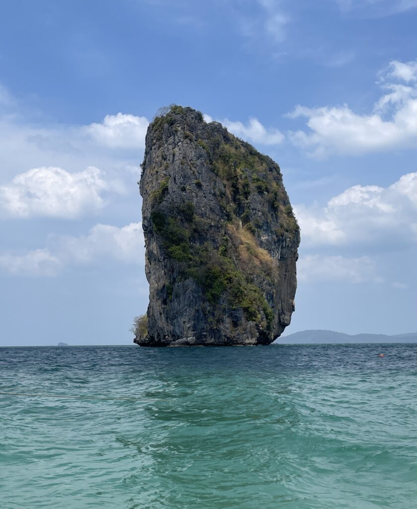 Ko Ma, an island rock formation in the middle of the ocean, being photographed from Ko Poda in Krabi