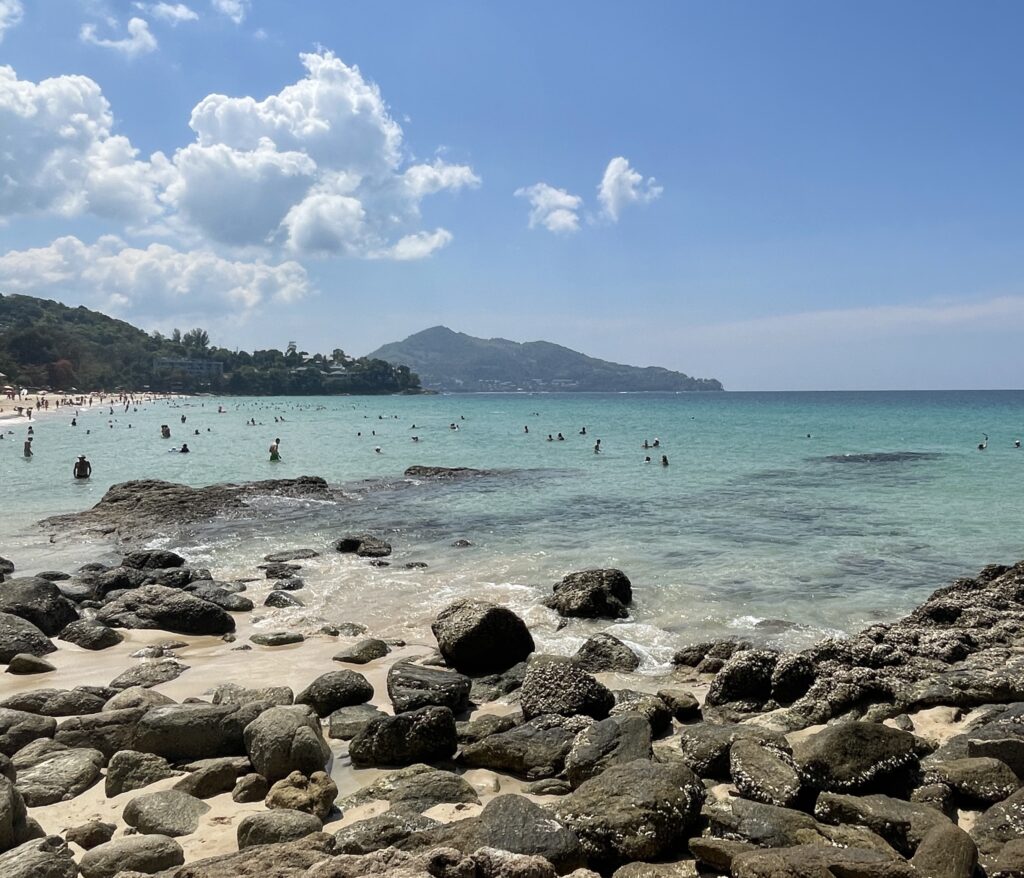 many rocks on the beach shorelines at Surin Beach in Phuket / worst time to visit Phuket and best time to visit Phuket