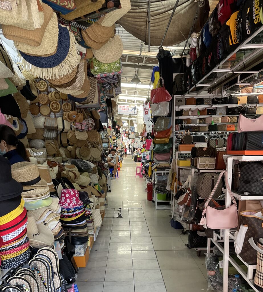 the interior space at Bangla Market in Patong, several hats and bags displayed up for sale