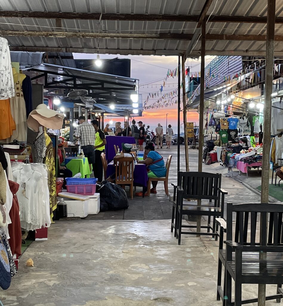 interior space at Bazar Karon with the sunset setting in at Karon Beach in the distance 