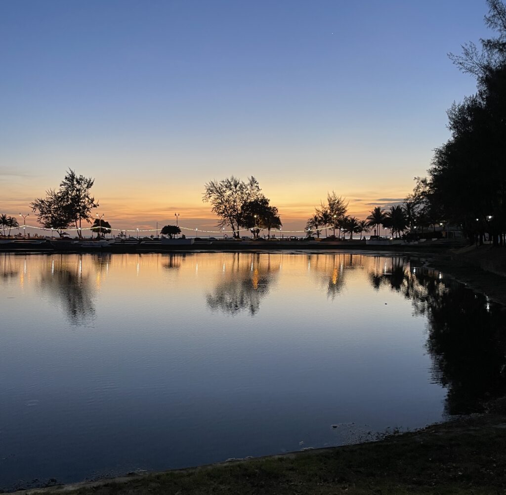 sunset being reflected along the pond water at Karon Park in Karon Village Phuket