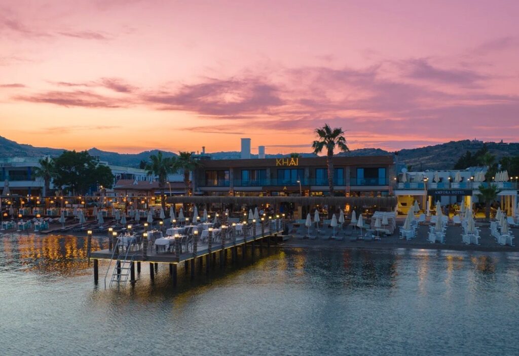 aerial views of the Khai hotel in Bodrum with a colourful sunset in the backgorund