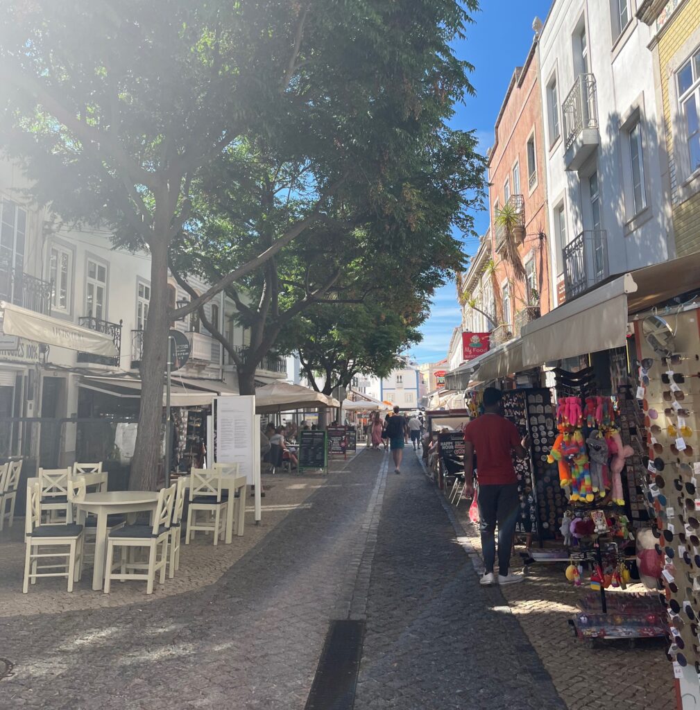 several shops and cafes on the side of the streets in Old Town Lagos, Portugal