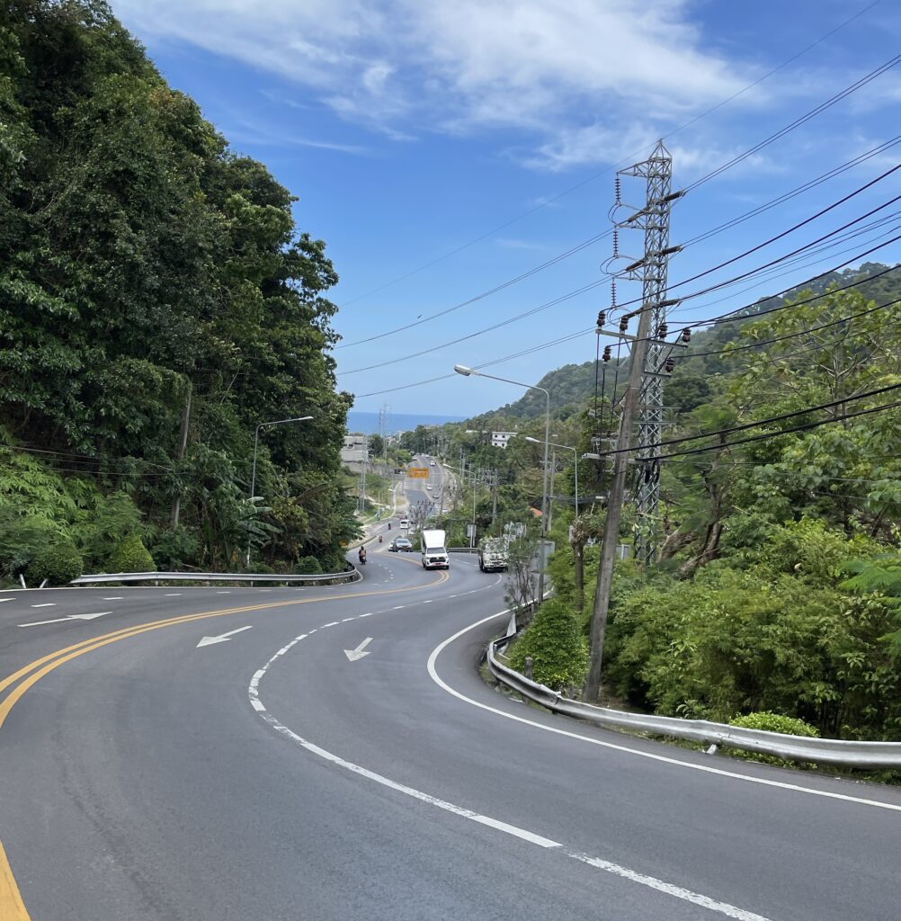 a winding uphill empty road in Phuket, Thailand