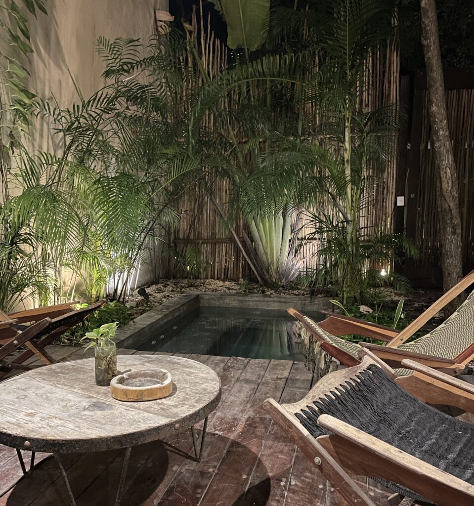 Trees and two chairs surrounding a Jacuzzi in Aldea Zama Tulum, Mexico