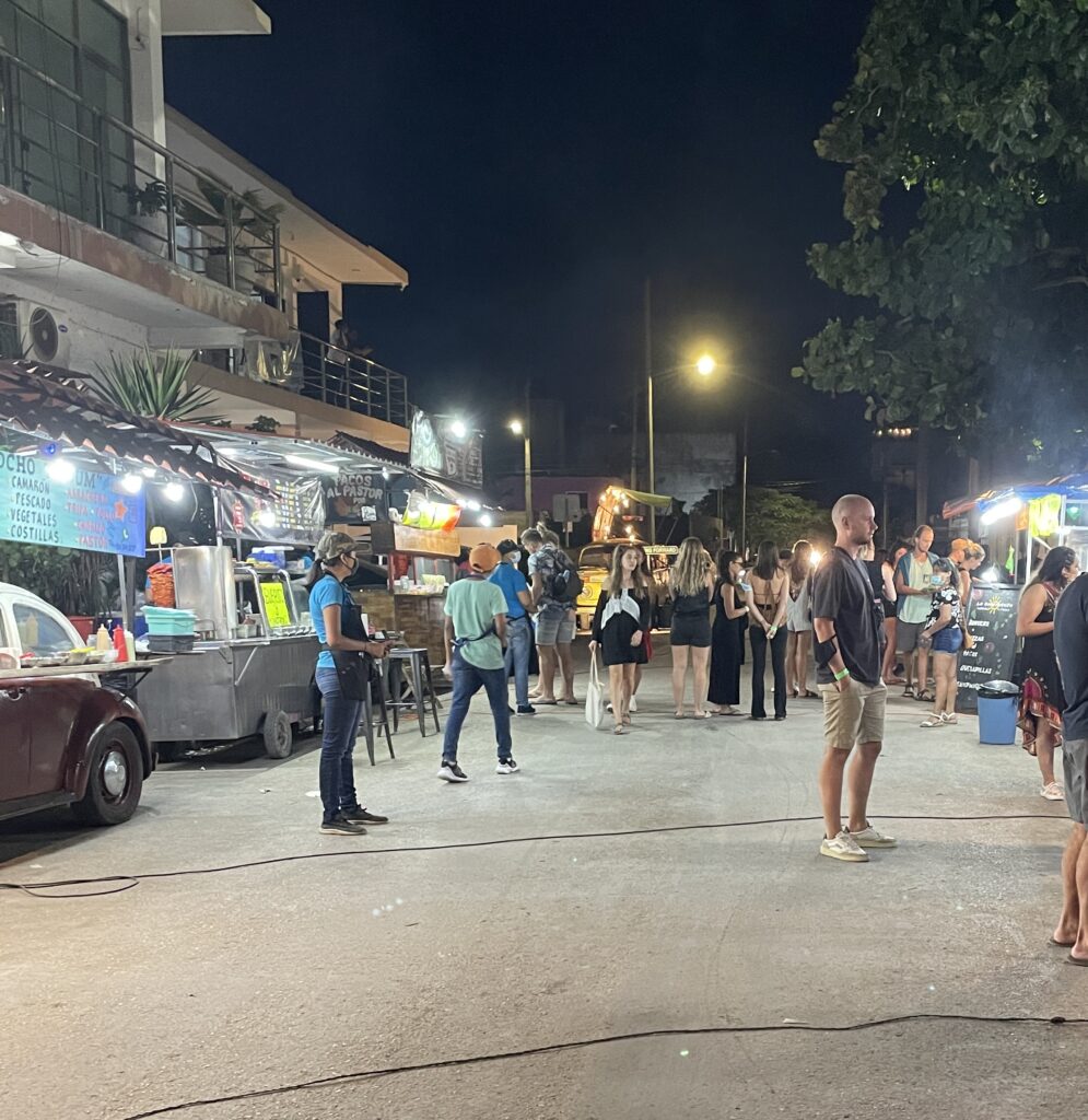 several taco stands serving customers in the evening in Tulum, Mexico