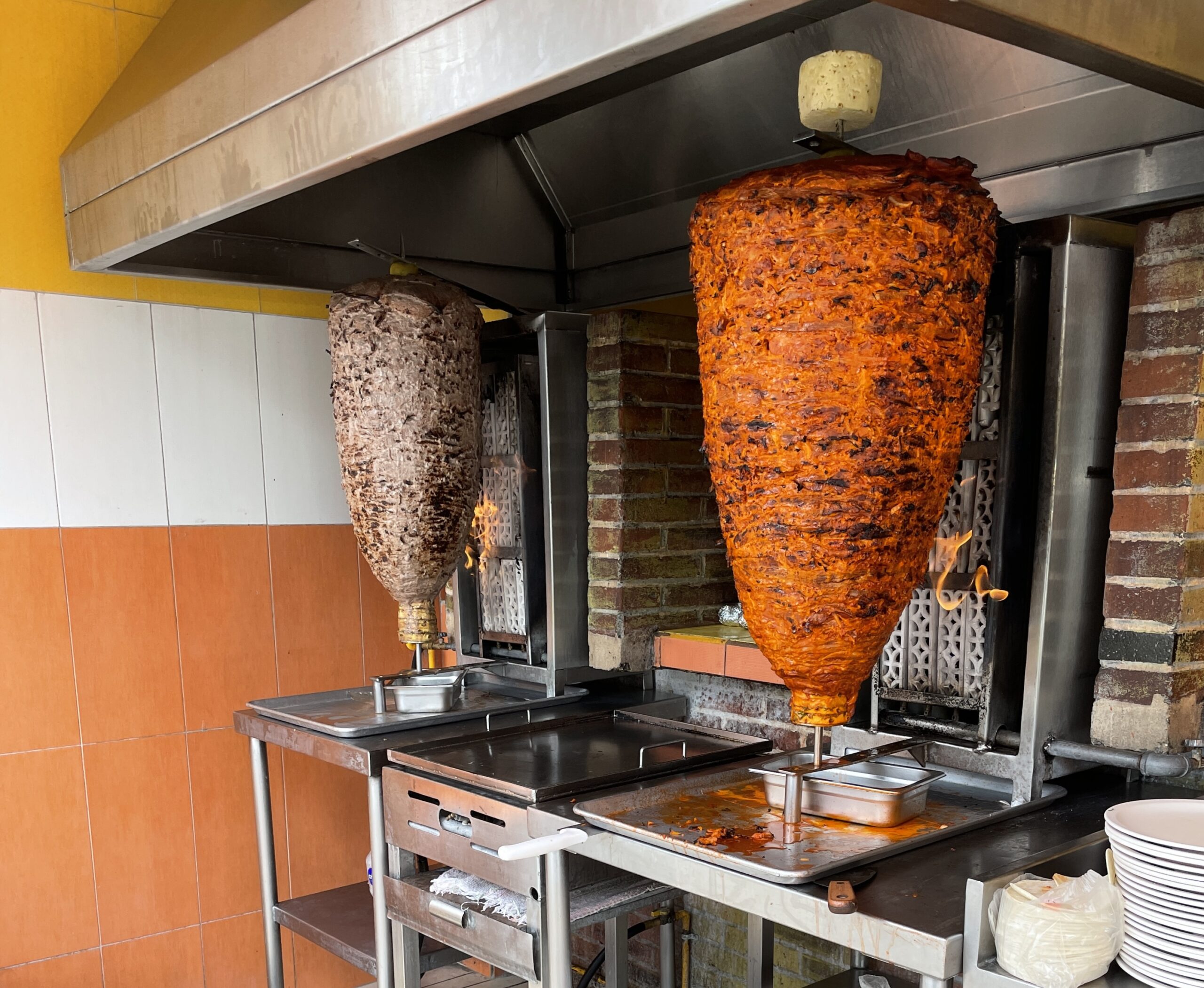 two large spits of meat being cooked at El Fogon known as one of the best tacos in Playa Del Carmen