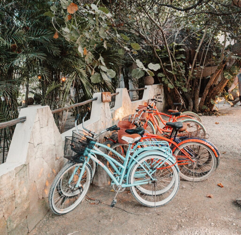 Several bicycles are parked on the side of the road in Tulum; bikes are popular regarding how to get around Tulum.